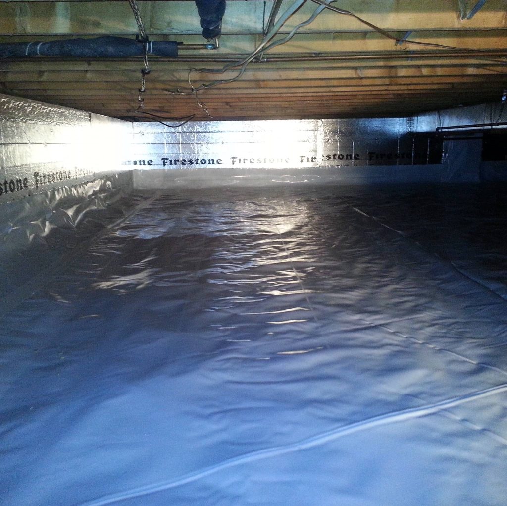 Crawl space fully encapsulated with a Firestone vapor barrier on the walls and floor, creating a clean, dry, and mold-free environment.
